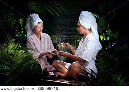 Portrait Of Young Beautiful Women Drinking Tea  In Spa Environment.