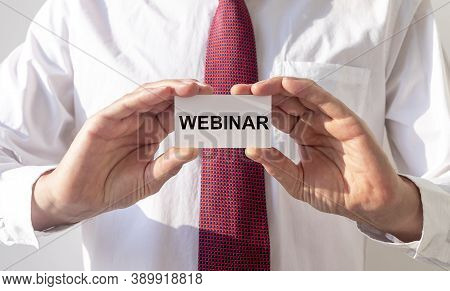 Word Webinar On Paper Card In Businessman Hands.