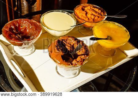 Chocolate Dessert Panna Cotta, Vanilla Puding, Fruit Jelly. Tasty Desserts In Glass Bowls