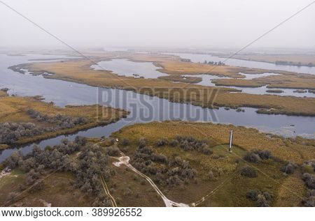 Aerial Shot Of The Misty Autumn Floodplains Of The Dnieper River With Reed Islands In The River