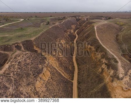 Aerial Shot Of Clay Hills With Canyons Near The Black Sea At Misty Autumn Weather. Stanislavs Mounta