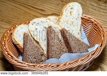Black And White Bread In A Basket. Sliced ??bread In A Basket. Pieces Of Bread Are Ready To Eat