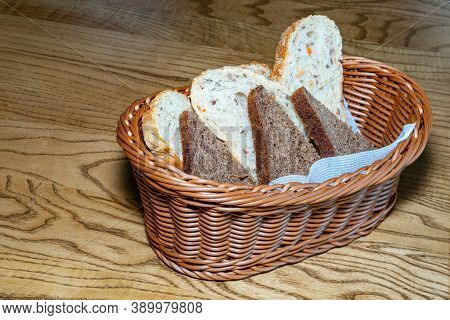 Black And White Bread In A Basket. Sliced ??bread In A Basket. Pieces Of Bread Are Ready To Eat