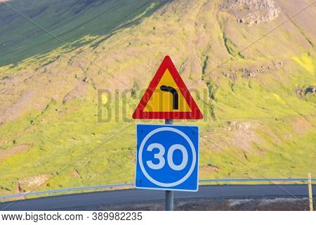 Sign Warning Of A Tight Corner And Advising On The Speed