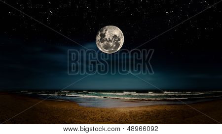 Full Moon Reflected On The Beach
