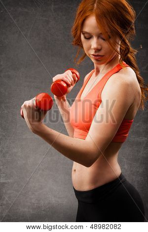 woman exercising with dumbbells