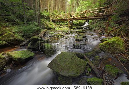 Brook With A Wooden Bridge