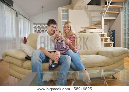 happy young family eating tasty pizza with cheesa and dring healthy and fresh orange juice