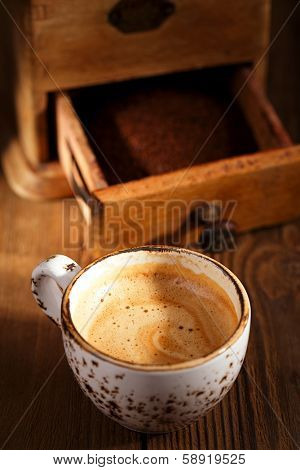 A cup of espresso coffee with Old coffee mill  textured tablem rustic style