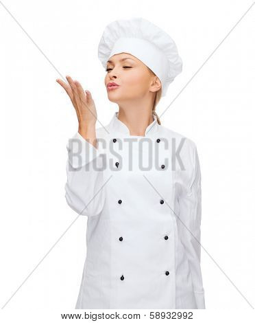 cooking, gesture and food concept - smiling female chef showing delicious gesture
