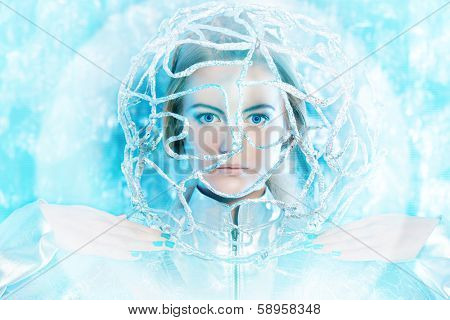 Beautiful young woman in silver latex costume with futuristic hairstyle and make-up. Sci-fi style.