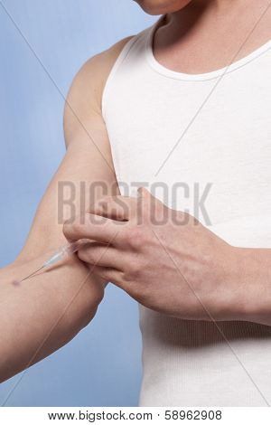 Drug addict man with syringe in action