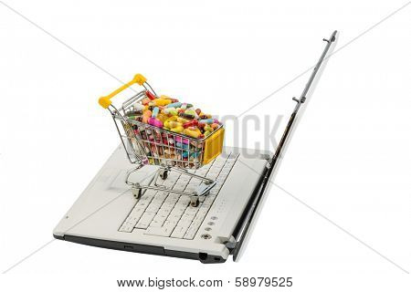 tablets with shopping cart and computer. symbolic photo for the purchase of medicines on the internet