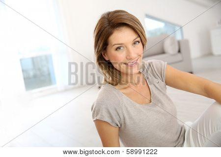 Smiling attractive woman relaxing at home