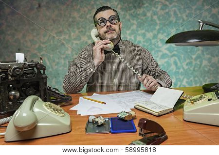 Employee With Glasses Talking On The Phone In The Office In The 1960S