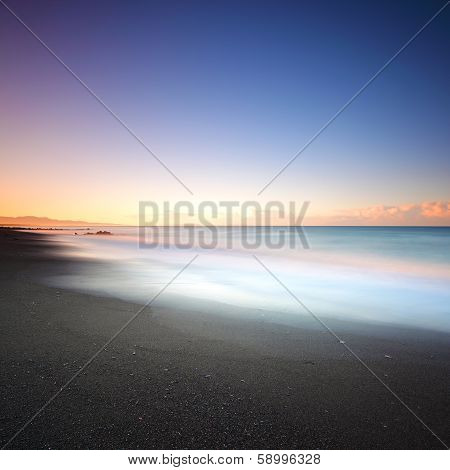 Beach Dark Sand And Sea On Morning. Tuscany Italy