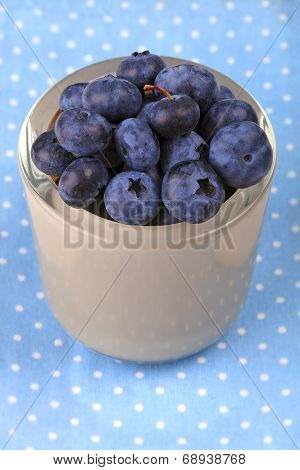 Blueberry in a bowl on blue dotted cloth