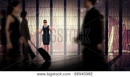 Redhead businesswoman in a blindfold against busy room with large window looking on city