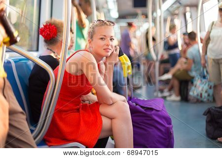 Lady traveling by metro.