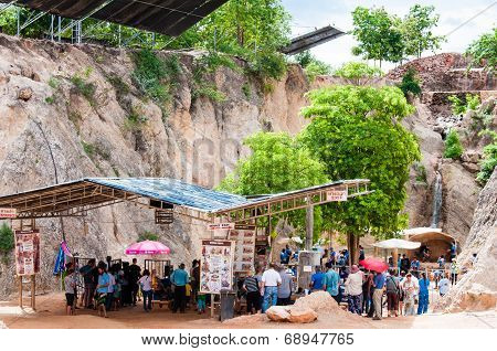 Tourists posing with tigers at the Tiger Temple in Kanchanaburi, Thailand.