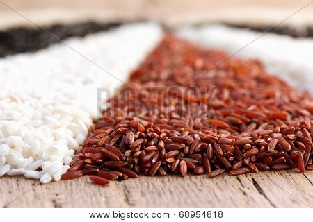 different types of rice on the old wooden table