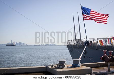 STATEN ISLAND, NY - MAY 25, 2014: The American flag flies from the stern of the guided-missile destroyer USS McFaul (DDG 074) docked at Sullivans Piers during Fleet Week NY on May 25, 2014. 
