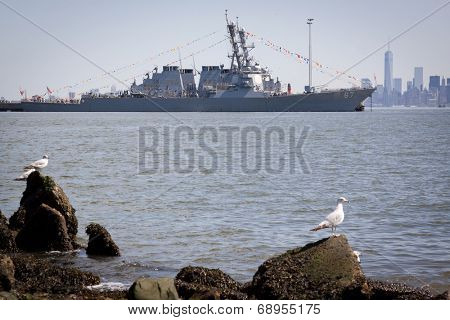 STATEN ISLAND, NY - MAY 25, 2014: The guided-missile destroyer USS Cole (DDG 067) moored at Sullivans Piers with the Freedom Tower and NYC skyline in the background on May 25, 2014.
