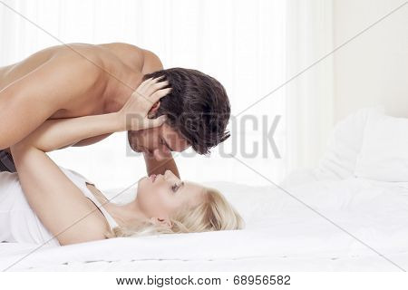 Affectionate young couple in bed