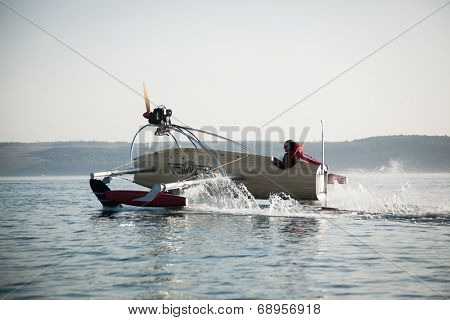 Portoroz, Slovenia - 6 May, 2014: Men riding a motorised vessel on foils in the sea.