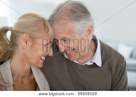 Cheerful senior couple looking at each other's eyes