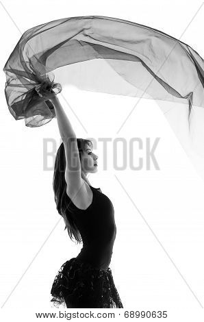 Young beautiful ballerina dancing with a flying veil