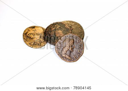 Four Old Coins With Portraits Of Emperors On A White Background
