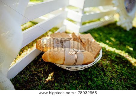 Buns And Cookies On The Plate Green Grass Background