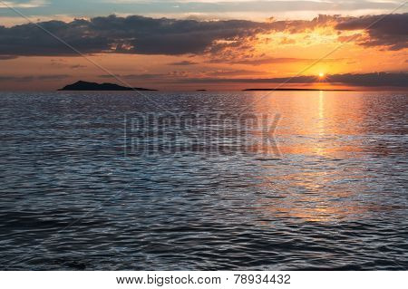 Sunset over lake alakol with clouds. Kazakhstan