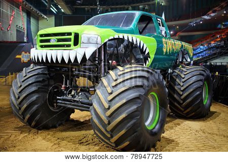 MOSCOW, RUSSIA - MAR 29, 2014: Green car with huge wheels, participant show Monster X Tour in Moscow