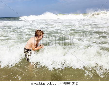 Boy Enjoys The Waves Of The Sea