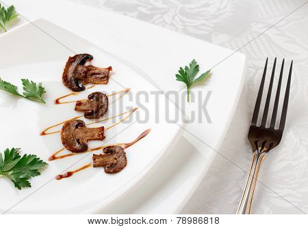 White Square Plate Decorated With Fried Mushrooms