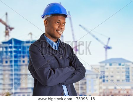 Portrait of a smiling black worker in front of a construction site