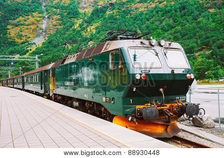 Flamsbahn In Flam, Norway. Green Train On Railway