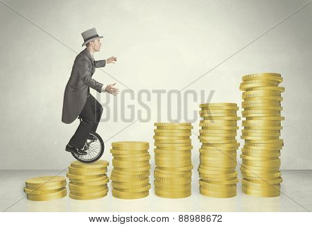 Business man riding monocycle up on coin graph concept on background