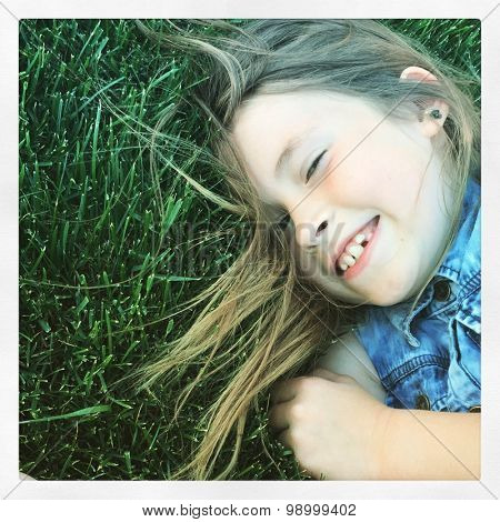 Girl having fun in grass - With Instagram effect