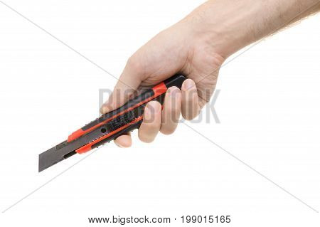 Clerical knife in a male hand on a white background isolation