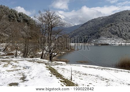Lake in the mountains in winter on a sunny day (Greece, mountainous Corinthia)