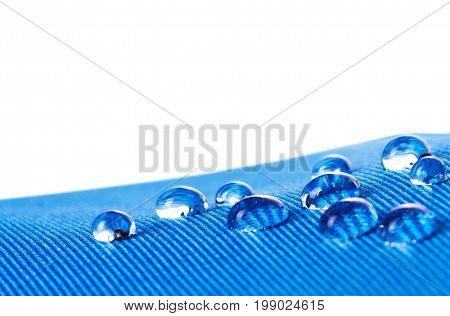 Waterproof fabric with waterdrops close up on white background