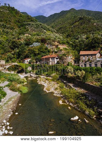 Photo of the stone bridge and river in the small old town of Badalucco in Italy in the province of Imperia the Italian region Liguria.