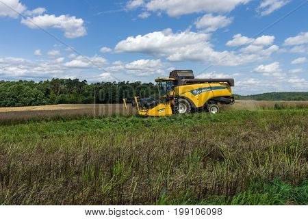 NEUSTADT GERMANY - JULY 30 2017: Harvesting on the fields in the suburbs of the small town of Neustadt (Marburg-Biedenkopf district in Hessen). Harvester on the field.