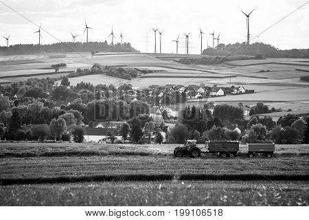 NEUSTADT GERMANY - JULY 30 2017: View of the small town of Neustadt a suburb and surrounding agricultural land and agricultural machinery. Black and white.