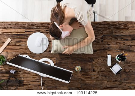Young Businesswoman Wearing Eyemask Sleeping On Pillow