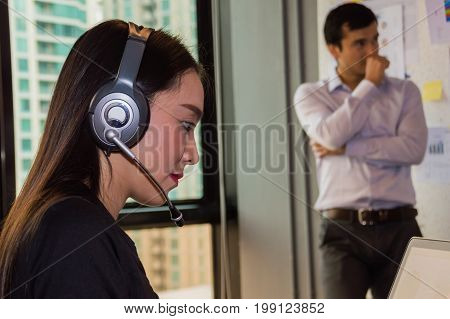 Callcenter is answering the phone customer question.