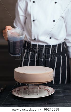 Pour Chocolate Frosting On A Mousse Cake